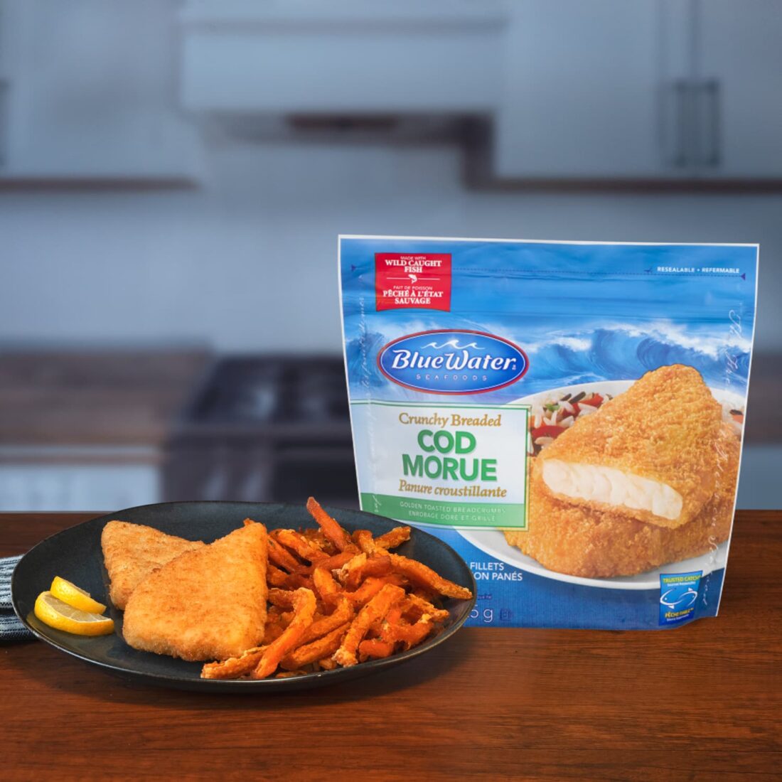 Plate of Breaded Cod Fillets and fries presented next to packaging