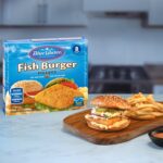 Dressed Fish Burger Fillet and fries presented next to packaging